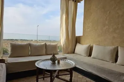 a living room with a couch and a table at Magnifique appartement spacieux avec une belle terrasse ensoleillée in Marrakech