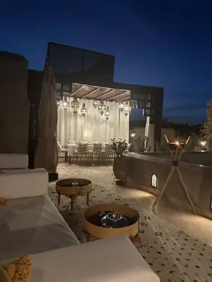 a living room with a couch and a table at Riad des Fragrances dar el Bacha in Marrakech