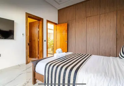 a bedroom with a bed with a black and white striped blanket at Manzal Vista in Marrakech
