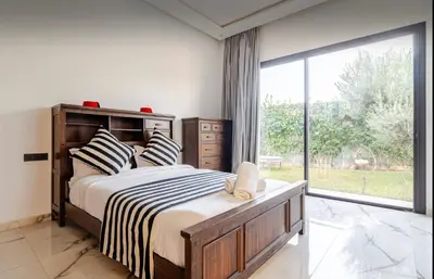 a bedroom with a large bed and a large window at Manzal Vista in Marrakech