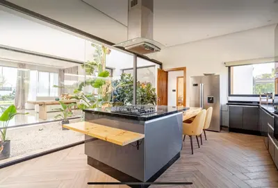 a kitchen with a large island with a table and chairs at Manzal Vista in Marrakech