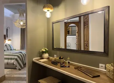 a bathroom with a vanity with a large mirror at Maison Maria Palmeraie in Marrakech