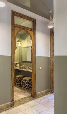 a bathroom with a large mirror and a sink at Maison Maria Palmeraie in Marrakech