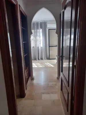 a hallway with an archway and an open door at Belle Vue in Marrakech