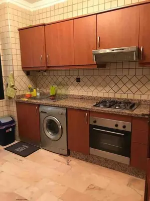 a kitchen with a stove and a washing machine at Belle Vue in Marrakech