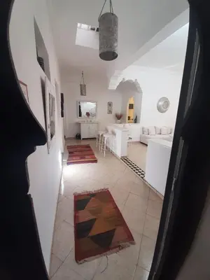 a living room with a couch and a table at DUPLEX MEDINA AVEC TERRASSE in Marrakech