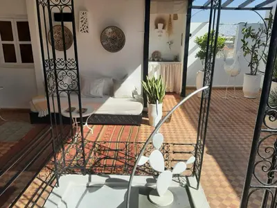 a living room with a couch and a table at DUPLEX MEDINA AVEC TERRASSE in Marrakech