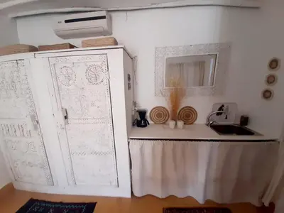 a kitchen with a sink and a cabinet with drawings on it at STUDIO LOFT MEDINA AVEC TERRASSE in Marrakech