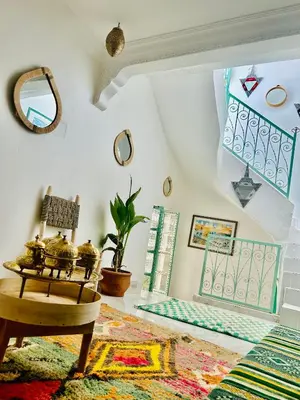 a living room with a chair and a rug at Maison Cascada in Marrakech
