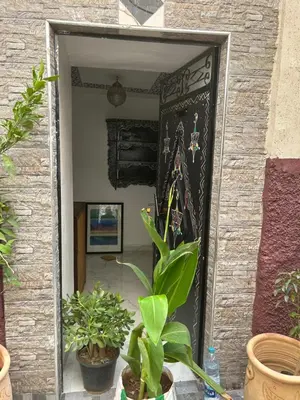 a doorway with a painting on a wall with plants at Maison Cascada in Marrakech