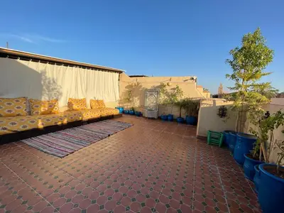 a patio with a couch on a house at Riad Mama Toutou in Marrakech