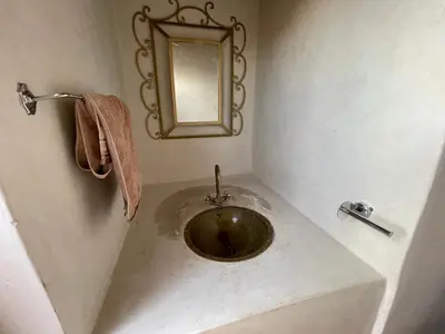 a sink in a bathroom with a mirror on the wall at Riad Mama Toutou in Marrakech