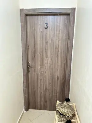 a wooden door with the number on it at Charming Room Near Marrakech Airport in Marrakech