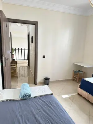 a bedroom with a bed and a view of the ocean at Charming Room Near Marrakech Airport in Marrakech