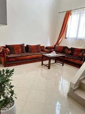a living room with a couch and a coffee table at Charming Room Near Marrakech Airport in Marrakech