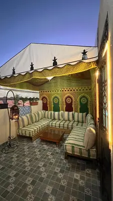 a living room with couches and a table at Riad dar Benaarab 2 aéroport 800 M in Marrakech