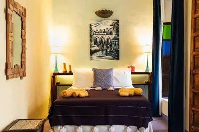 a bedroom with a bed with stuffed animals on it at Riad Taghia in Marrakech