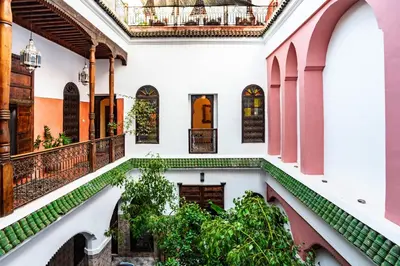 an indoor courtyard with plants in a building at Riad Taghia in Marrakech