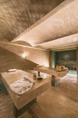 a large room with a bed and a sink at JEMAA EL FNA Suites & Spa in Marrakech
