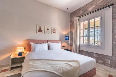 a bedroom with a large bed and a window at JEMAA EL FNA Suites & Spa in Marrakech