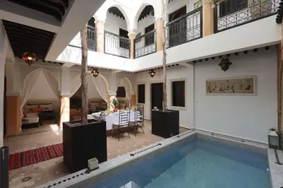 a house with a swimming pool and a living room at Riad 22 - L'Etoile d'Orient in Marrakech