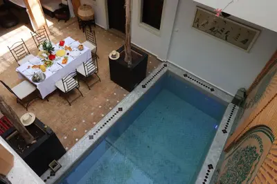 an overhead view of a table and a pool at Riad 22 - L'Etoile d'Orient in Marrakech