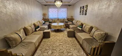 a waiting room with couches and a table in it at Appartement moderne, confort avec piscine et clim in Marrakech