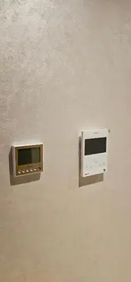 two microwaves are attached to a wall at Appartement moderne, confort avec piscine et clim in Marrakech