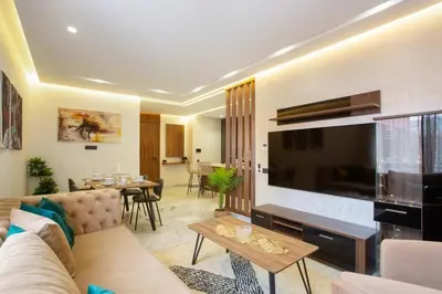 a living room with a couch and a large television at Luxury apartment in center Of Marrakech City in Marrakech