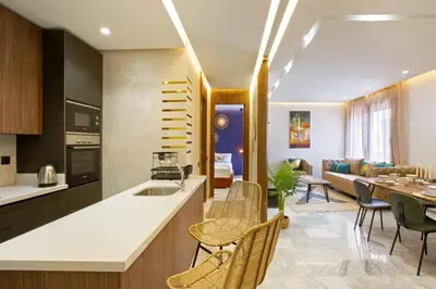 a kitchen and living room with a table and chairs at Luxury apartment in center Of Marrakech City in Marrakech