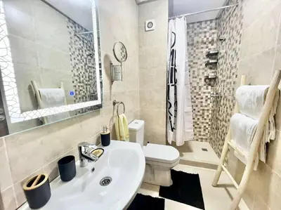 a bathroom with a white sink and a toilet at Cozy&Elegant apartment/pool/city center/Gueliz in Marrakech