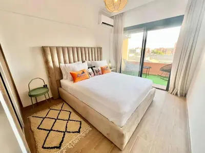 a bedroom with a large bed and a large window at Cozy&Elegant apartment/pool/city center/Gueliz in Marrakech