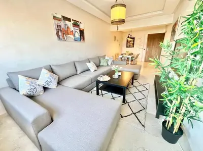 a living room with a couch and a table at Cozy&Elegant apartment/pool/city center/Gueliz in Marrakech