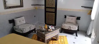 a living room with two chairs and a table at Riad Les Gazelles D'Orient Marrakech in Marrakech