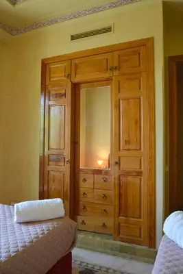 a bedroom with a wooden dresser with a mirror at Palmeraie Stay - Pool & Lake in Marrakech