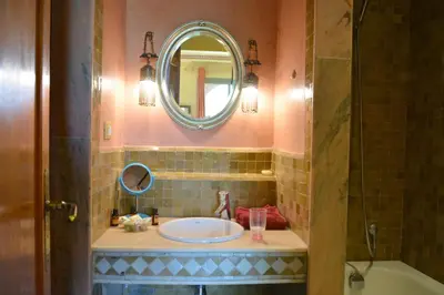 a bathroom with a sink and a mirror at Palmeraie Stay - Pool & Lake in Marrakech