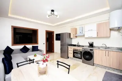 a kitchen and a living room with a table at Appartement Marrakech Hivernage. in Marrakech