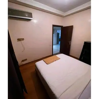 a bedroom with a bed and a phone on the wall at Gueliz budget Stay in Marrakech