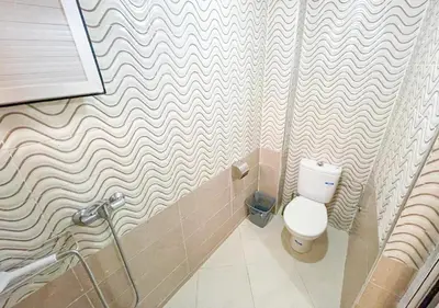 a bathroom with a toilet and a shower curtain at Sun Hostel in Marrakech