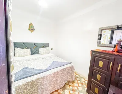 a bedroom with a bed and a dresser at Sun Hostel in Marrakech