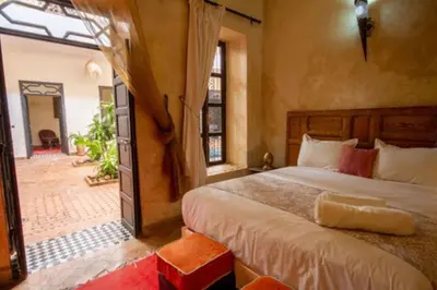a bedroom with a large bed in a room at Riad en Exlusivité à 5min de la place jamaa el fna in Marrakech