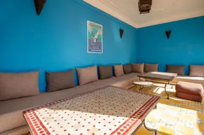 a living room with a couch and a blue wall at Riad en Exlusivité à 5min de la place jamaa el fna in Marrakech