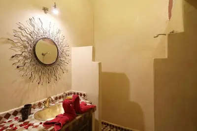 a bathroom with a sink and a mirror on the wall at Riad en Exlusivité à 5min de la place jamaa el fna in Marrakech