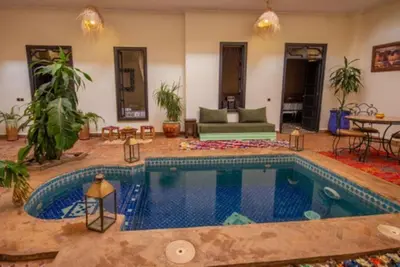 a large swimming pool in a living room at Riad en Exlusivité à 5min de la place jamaa el fna in Marrakech