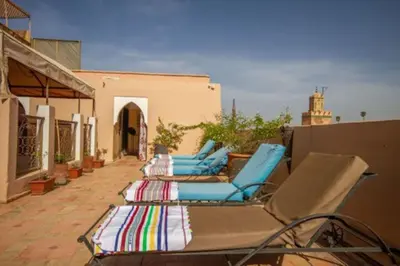 a group of lounge chairs sitting on a patio at Riad en Exlusivité à 5min de la place jamaa el fna in Marrakech