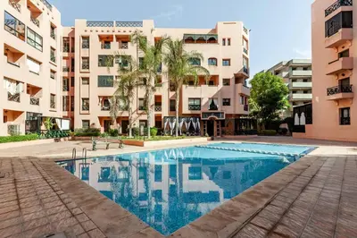 a swimming pool in front of some apartment buildings at OASIS PALM MARRAKECH APARTMENT- 5 Piscines in Marrakech