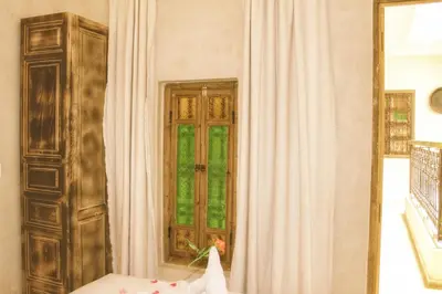 a room with a door and a window and a curtain at Riad Belikoss Pool & SPA in Marrakech