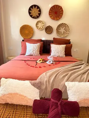 a bedroom with a large bed with a red blanket at Pierre précieuse au cœur de l'hivernage J40 in Marrakech