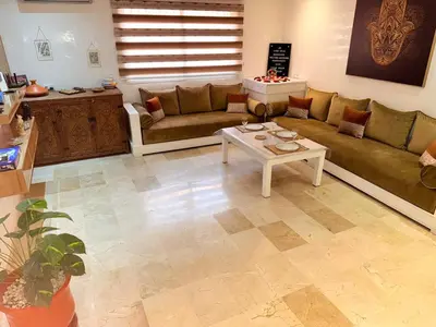 a living room with a couch and a table at Pierre précieuse au cœur de l'hivernage J40 in Marrakech