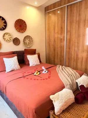 a bedroom with a large bed with a red blanket at Pierre précieuse au cœur de l'hivernage J40 in Marrakech